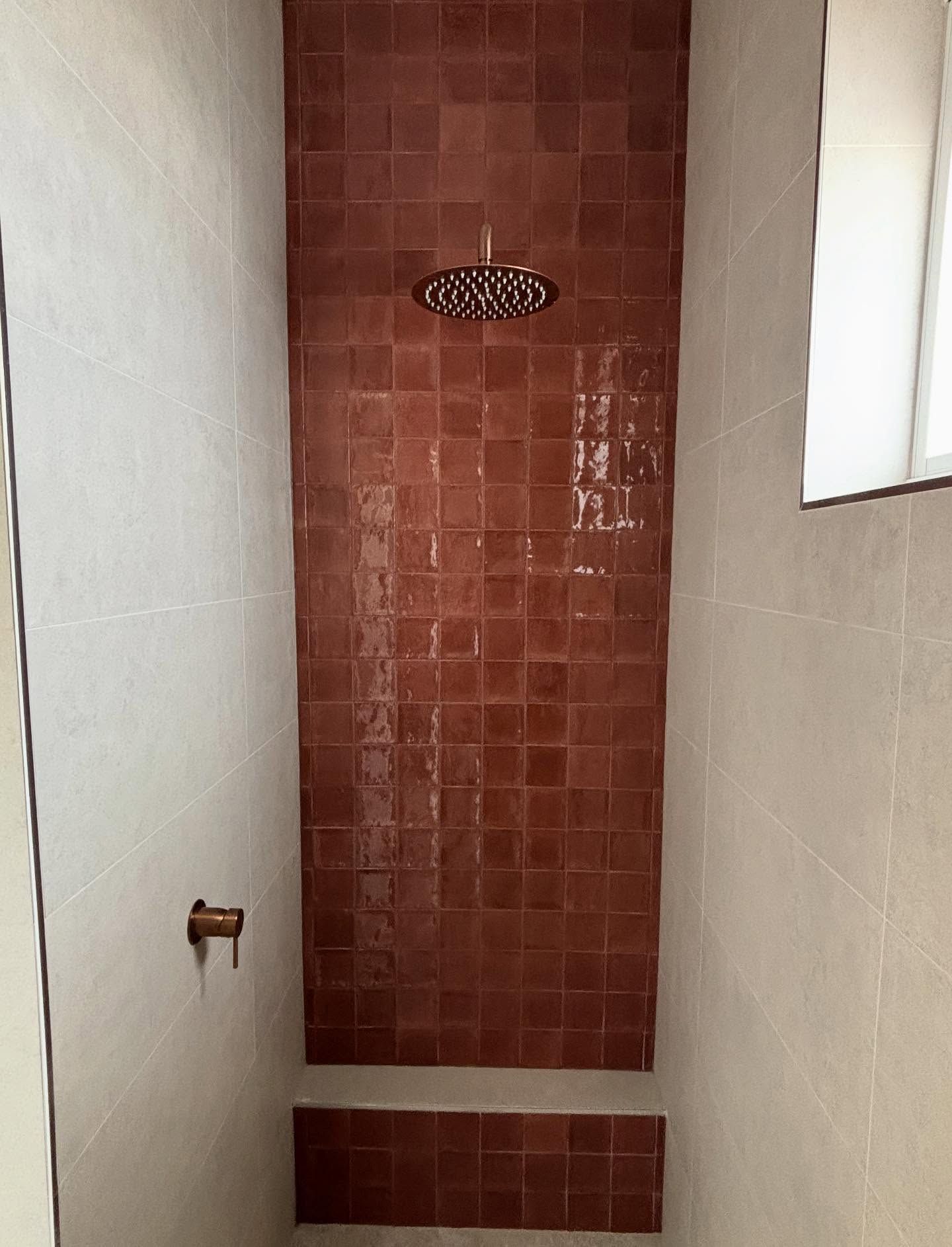 Narrow Bathroom Shower With Red Tiled Back Wall and White Side Walls — JAJ Plumbing in Mount Austin, NSW