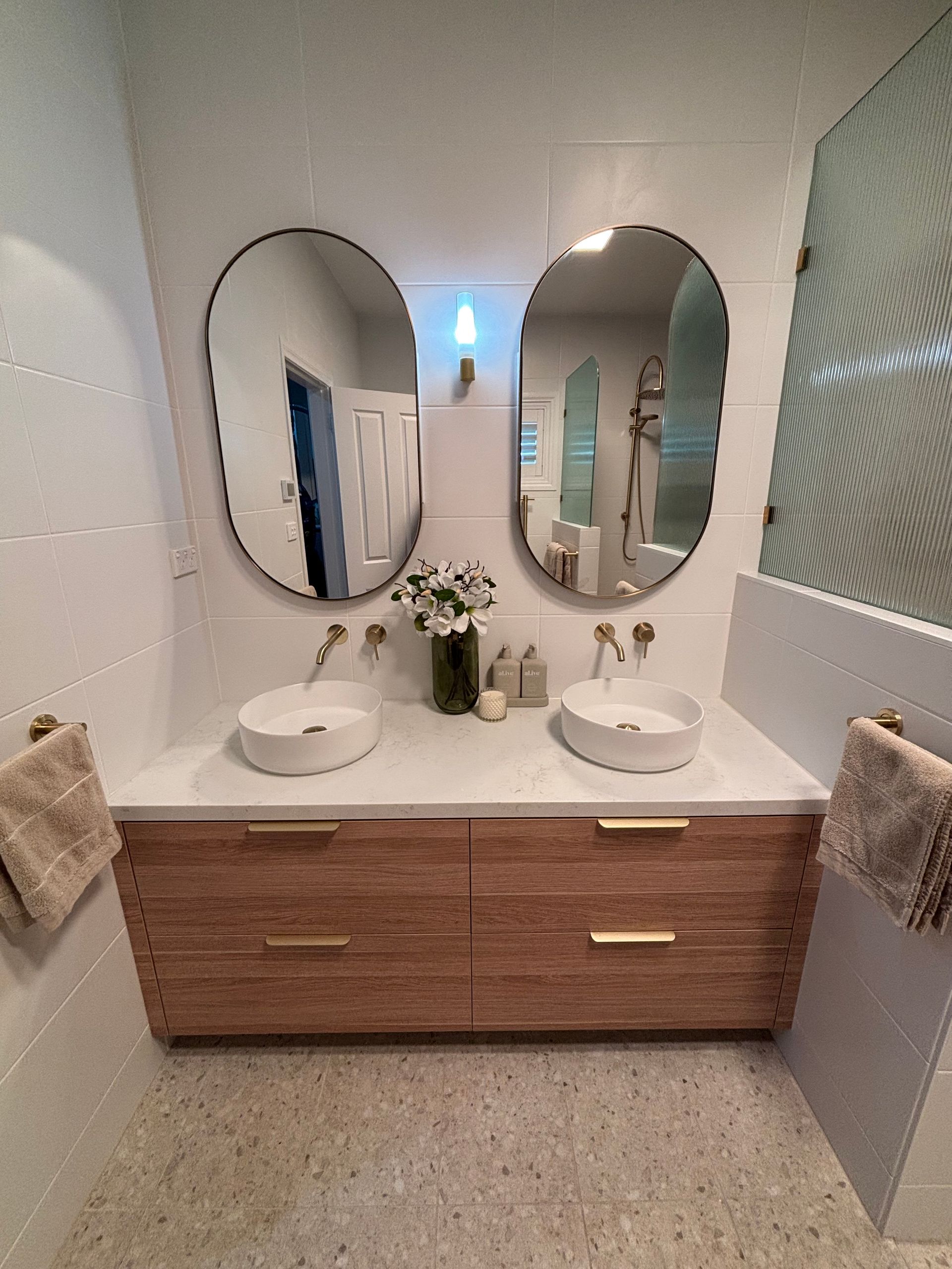 Modern Bathroom Vanity With Double Sinks, Oval Mirrors, Wood Cabinet — JAJ Plumbing in Mount Austin, NSW