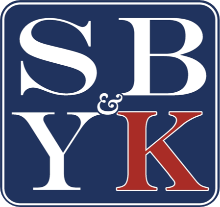 Blue square logo with white S, B, Y and red K letters separated by an ampersand.