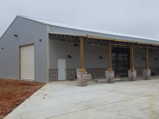 A large building with a covered porch and a garage door