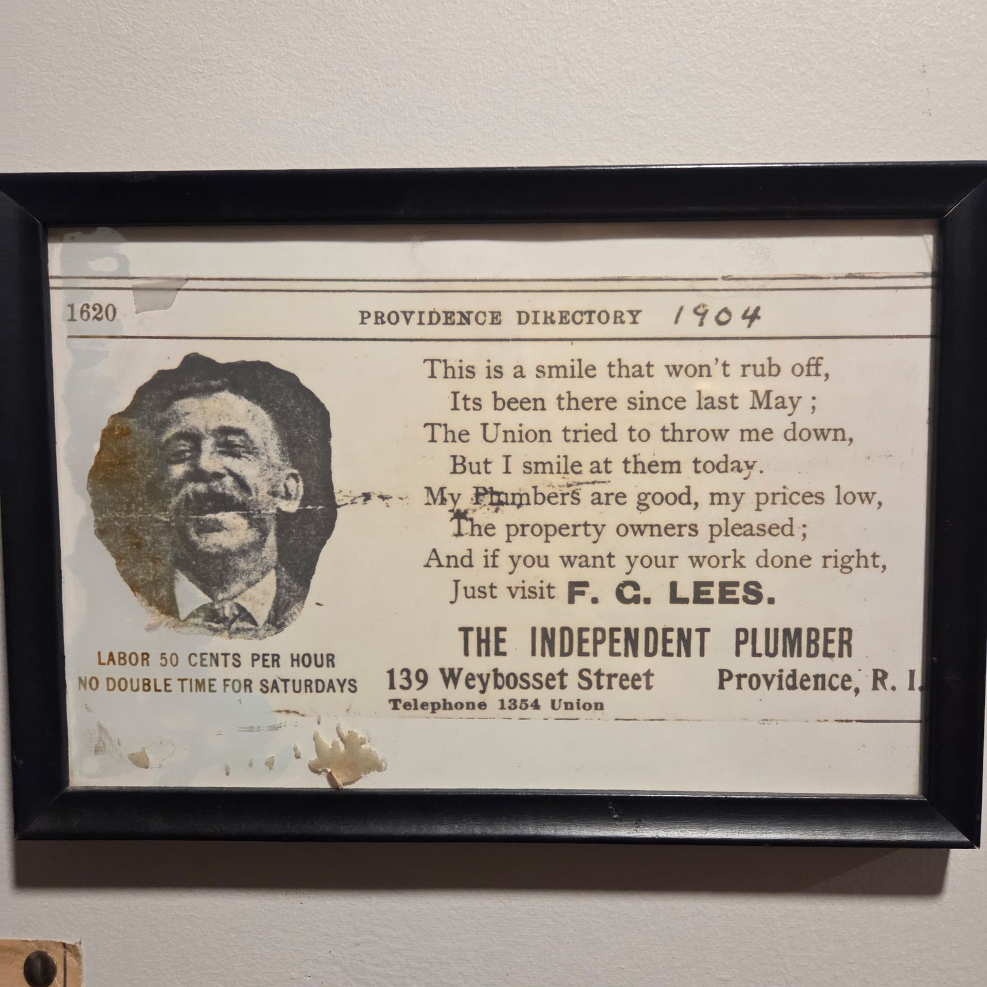 Vintage framed ad for The Independent Plumber, with black-and-white portrait and Providence directory text.
