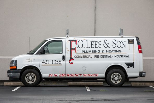 White plumbing service van with “F.G. Lees & Son” lettering parked on a street.