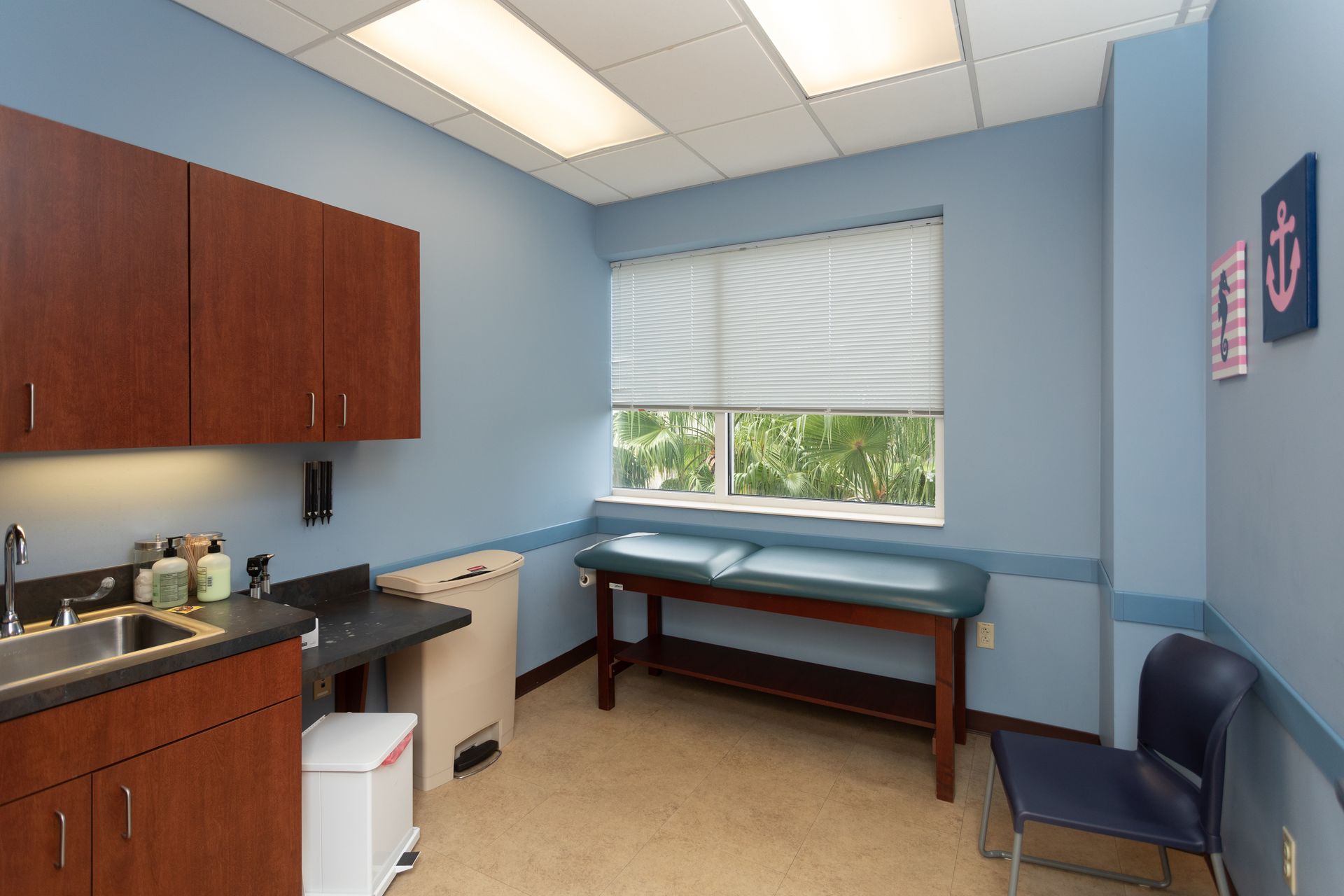 A doctor 's office with a table and a sink