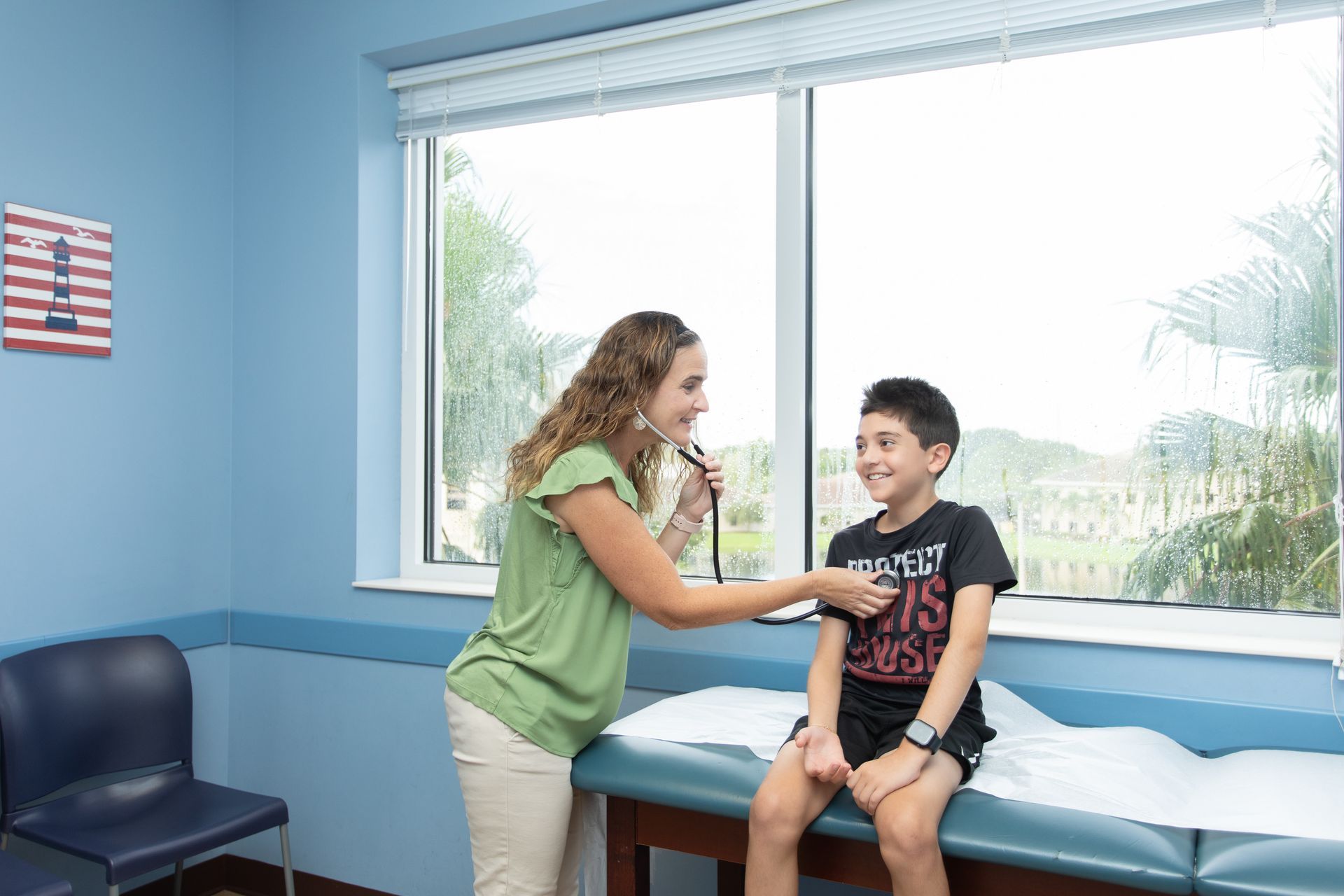 A pediatrician at Children's Medical Center is listening to the heartbeat of a child in an exam room