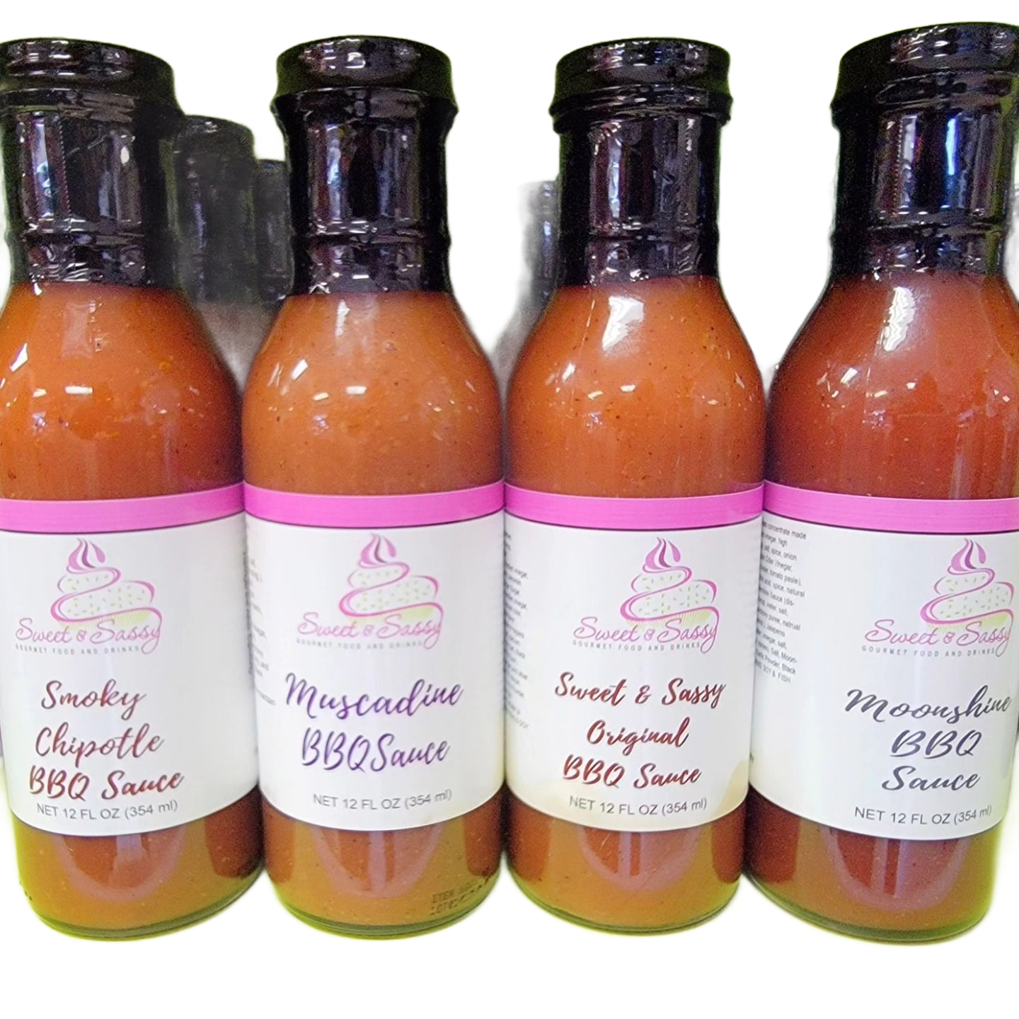 Four bottles of Sweet & Sassy BBQ sauce: Smoky Chipotle, Muscadine, Original, and Moonshine flavors.