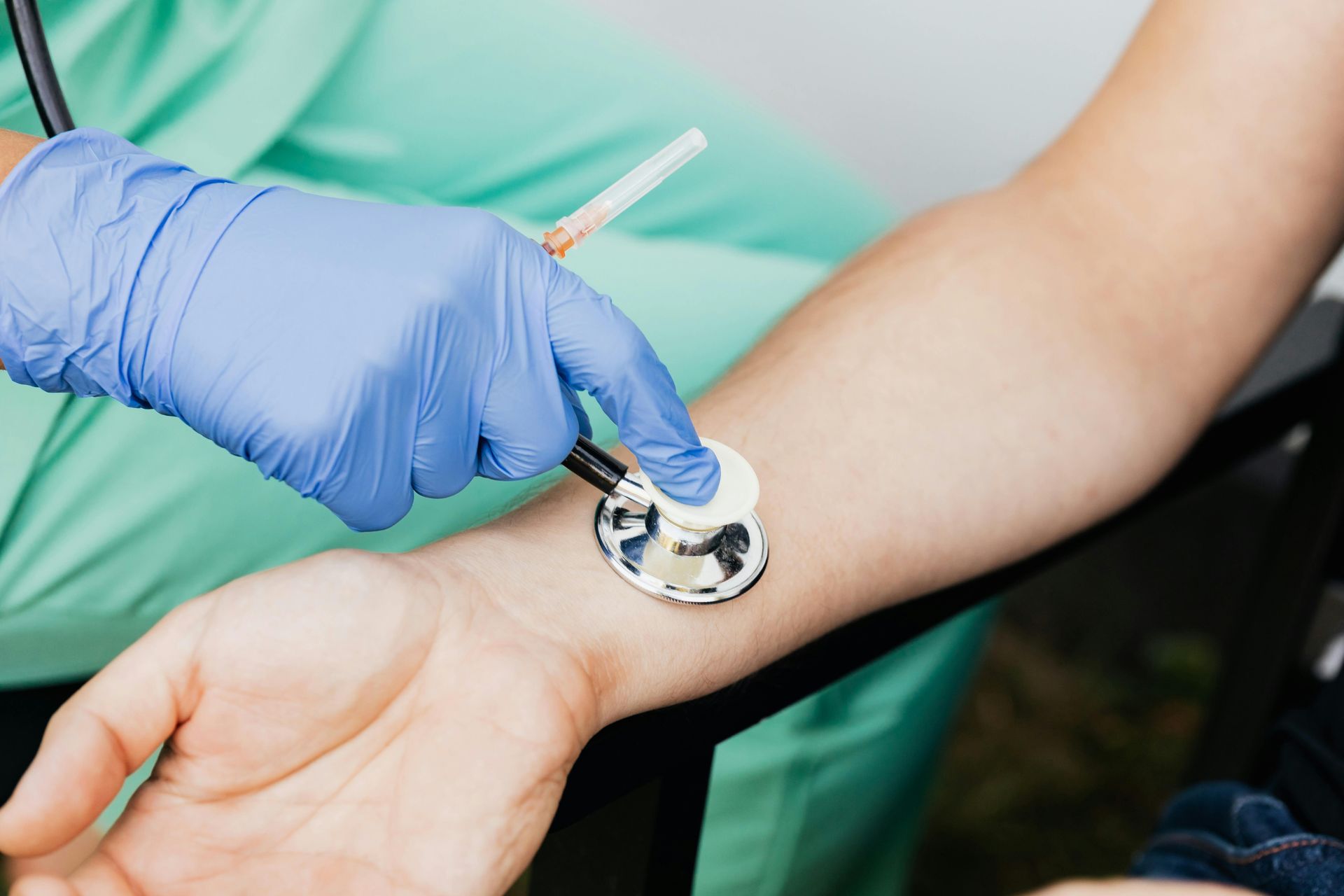 Hombre en cinta de correr con electrodos conectados; médico ajustando los cables. Entorno médico.