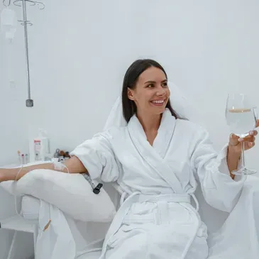 Patient receiving IV glutathione therapy in a robe at Renewed Health and Wellness