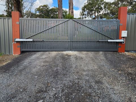 Automated driveway gate system installed on residential property