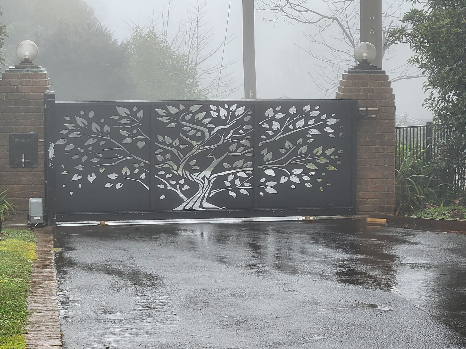 Custom designed timber-look gate complementing a home entrance