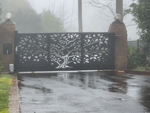 Custom designed timber-look gate complementing a home entrance