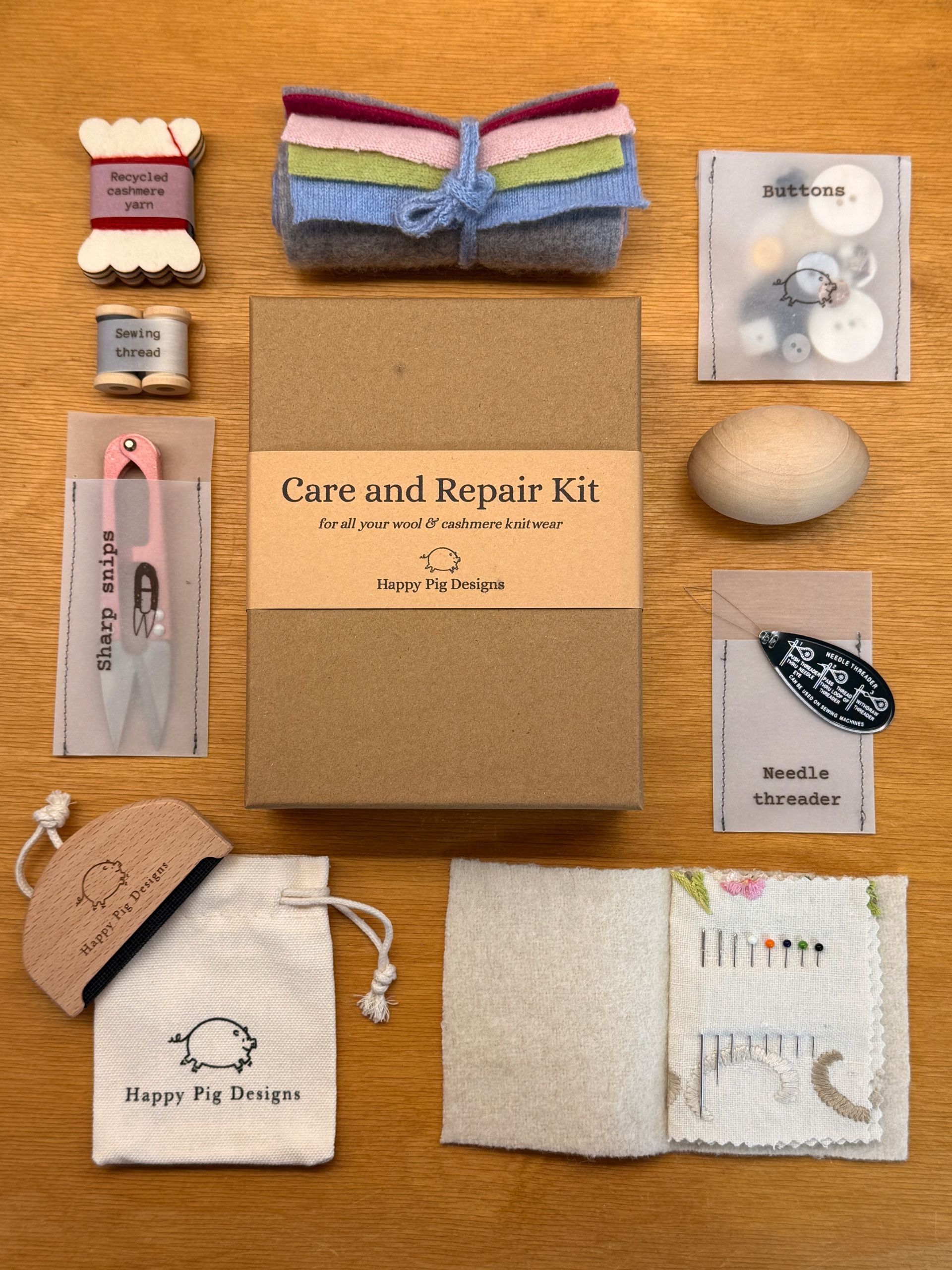 photo of a cashmere care and repair kit  with the contents of the kit laid out around the box. 