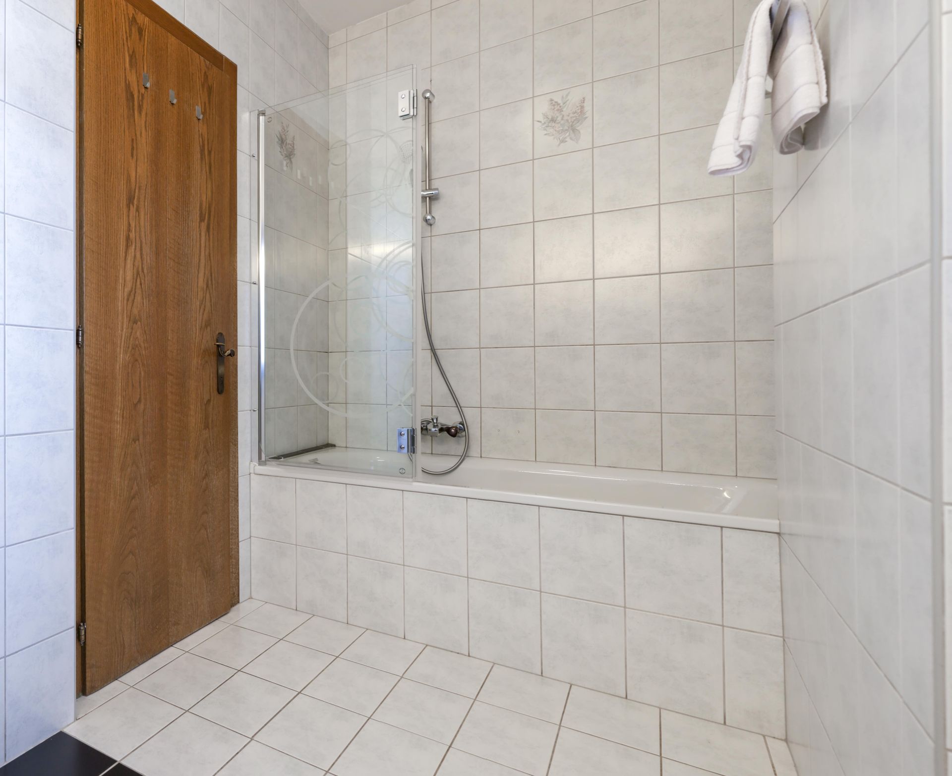 A bathroom with a bathtub and a shower stall