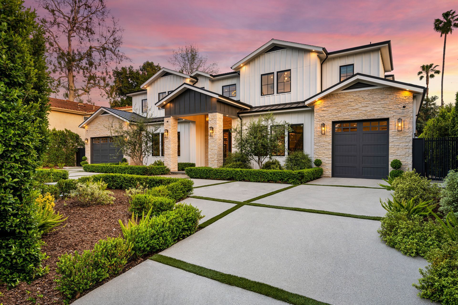 A house in a charming neighborhood with stunning sidewalk landscaping.