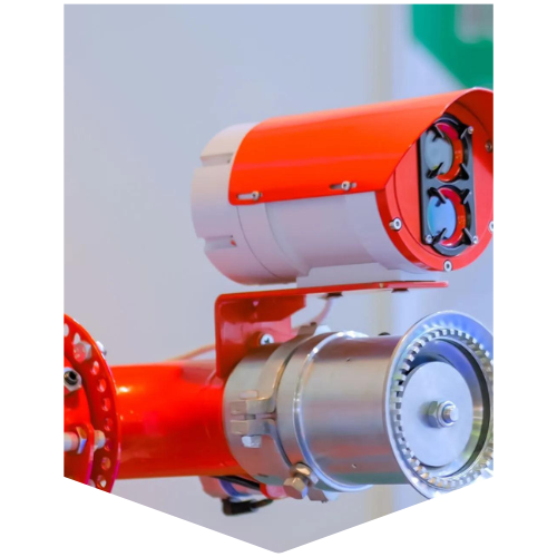 Orange and white industrial monitoring device on a red pipe, possibly for safety or measurement.
