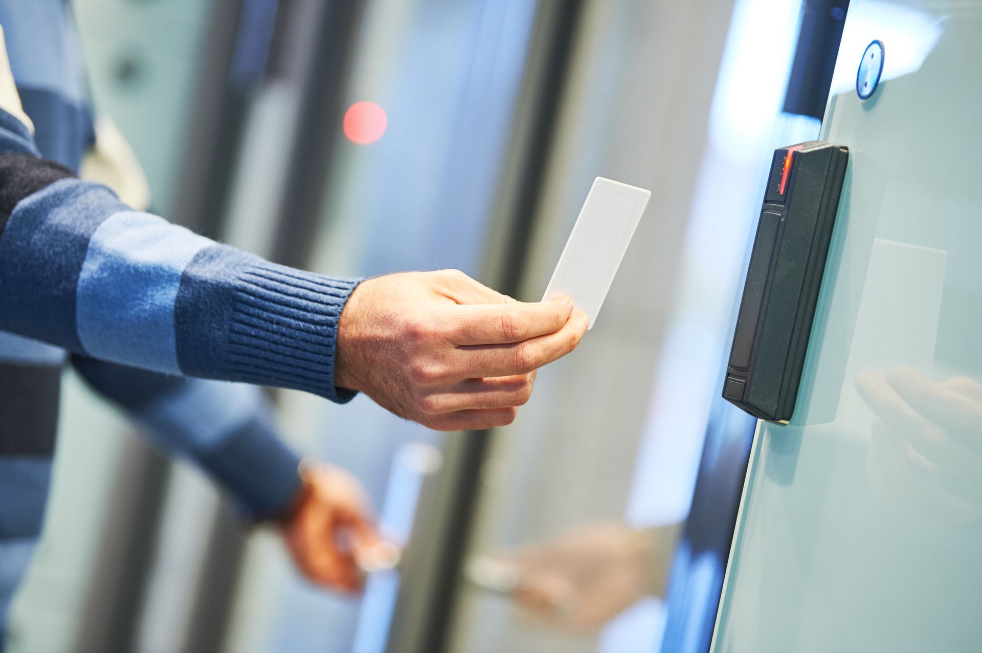 a person holding a card in front of a door a person holding a card in front of a door