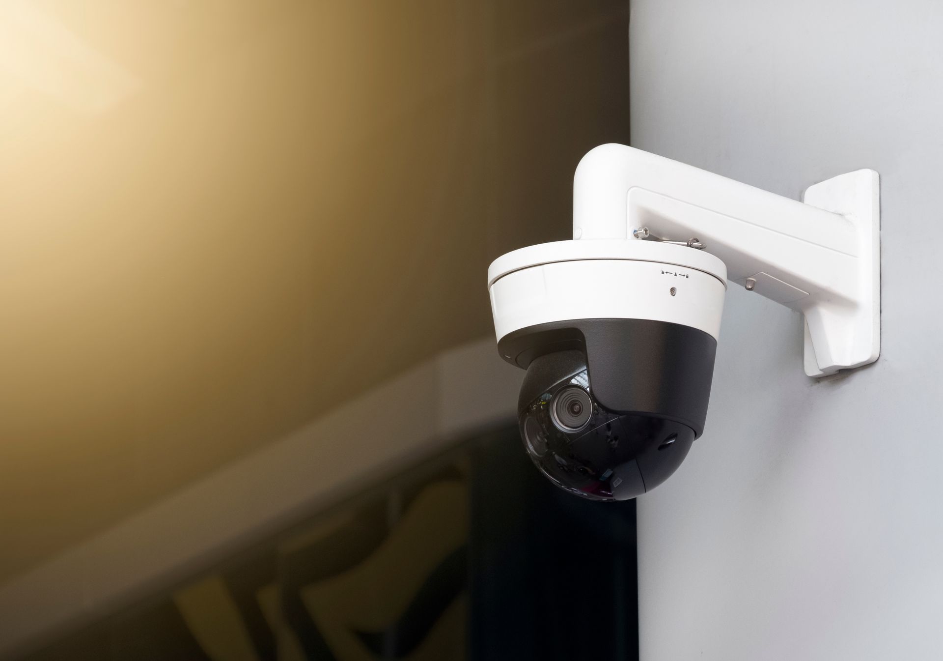 a security camera is mounted to a wall and has the word ip on it a security camera is mounted to a wall and has the word ip on it