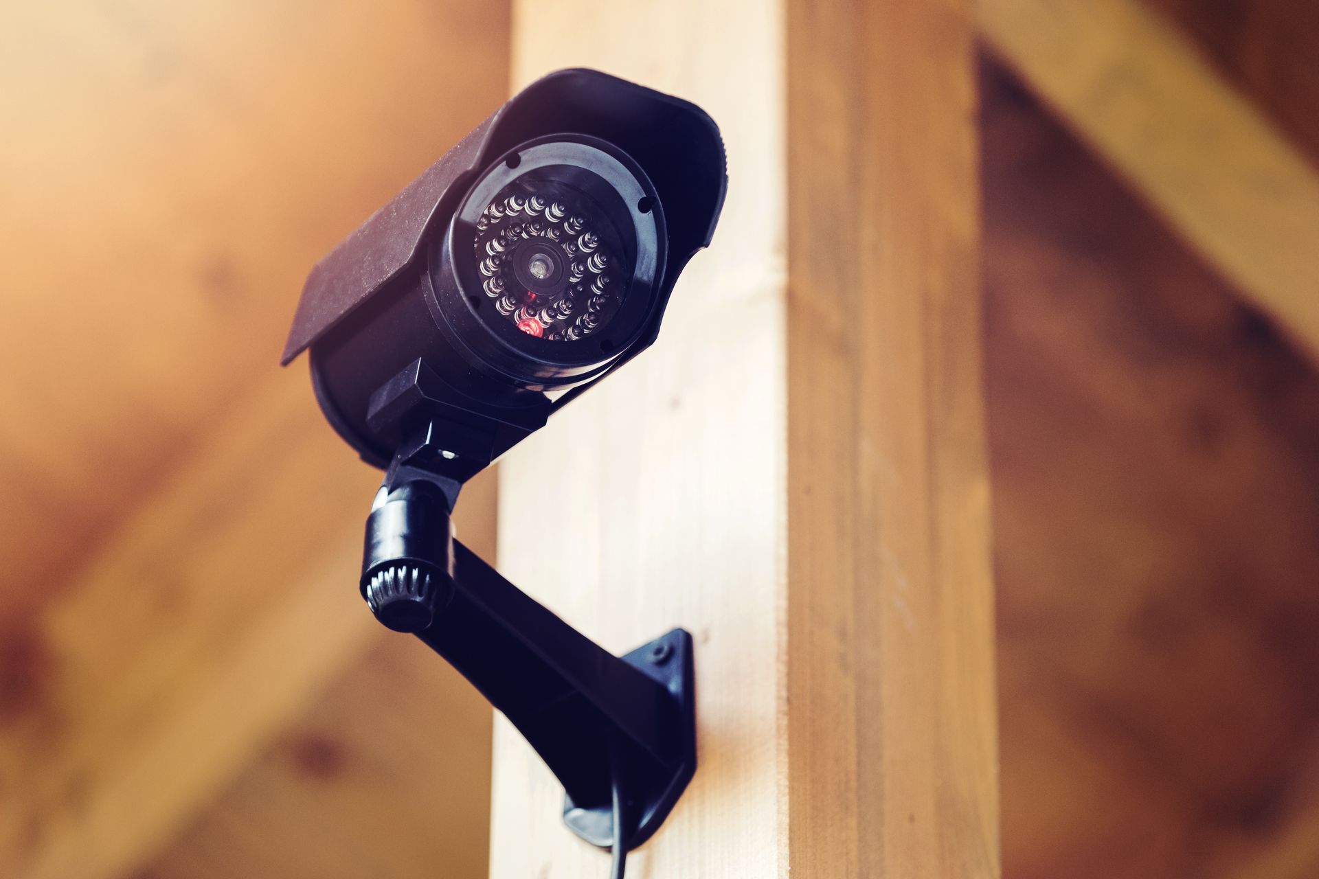 a security camera is mounted to a wooden post