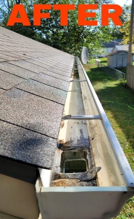 Damaged roof gutter with open downspout and debris beside gray shingles, marked “AFTER”