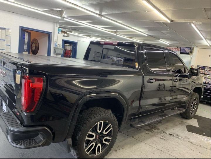 Window tinting a black pickup truck