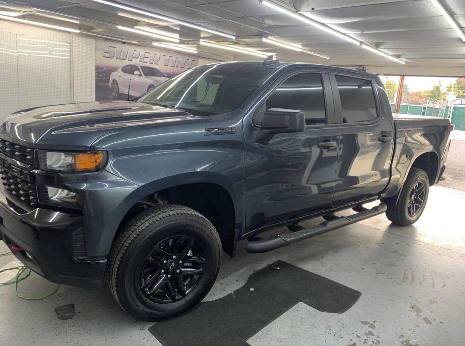 Window tinting a blue chevy truck