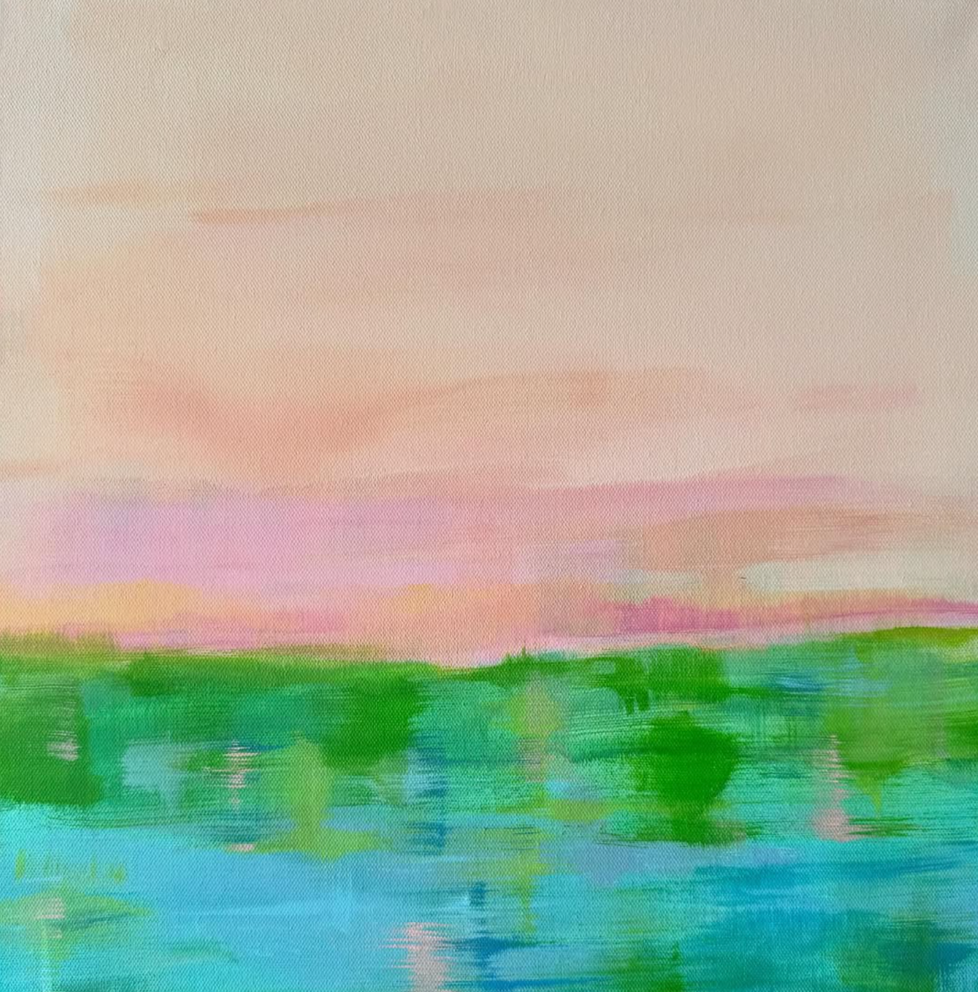 Pink and peach sunset over a bright green tree line, with a turquoise lake in the foreground.