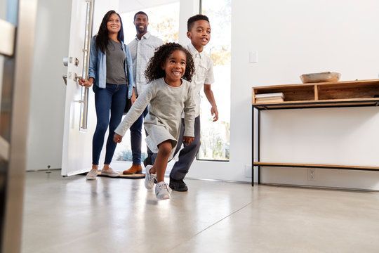 family smiles in their manufactured home covered by insurance