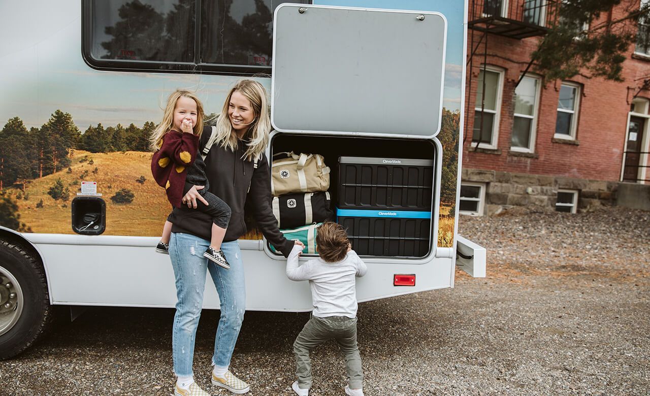 mom and kids stand by rv with camper insurance