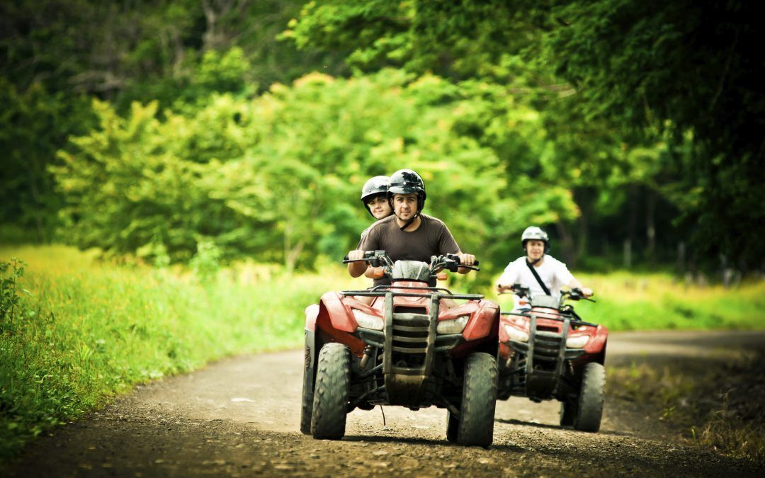 people on atv with insurance protection