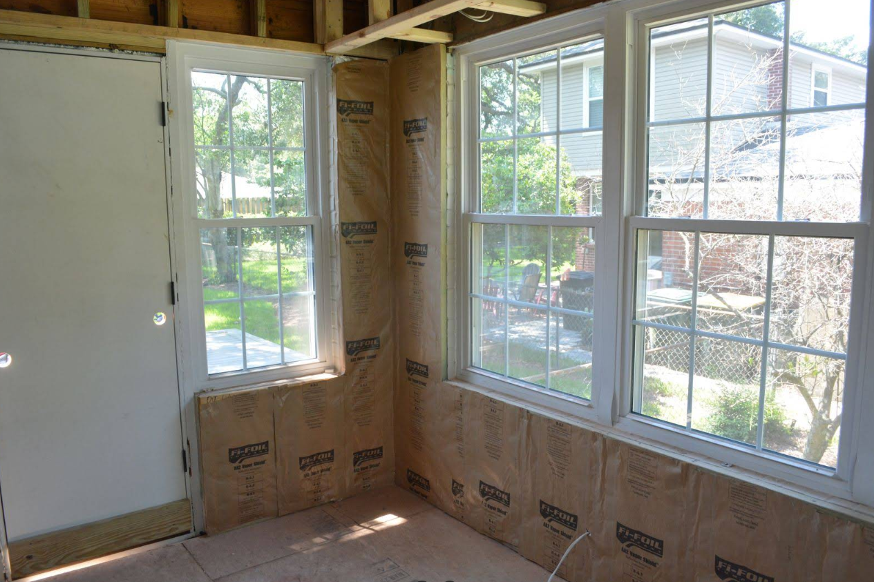 Interior view of room under construction with windows and insulation.