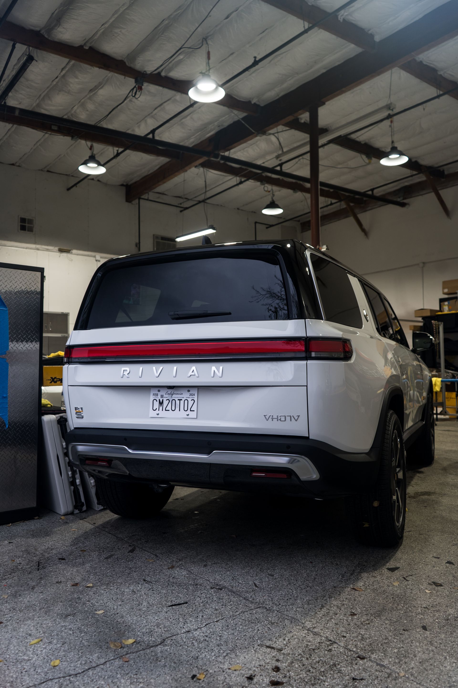 A white suv is parked in a garage.