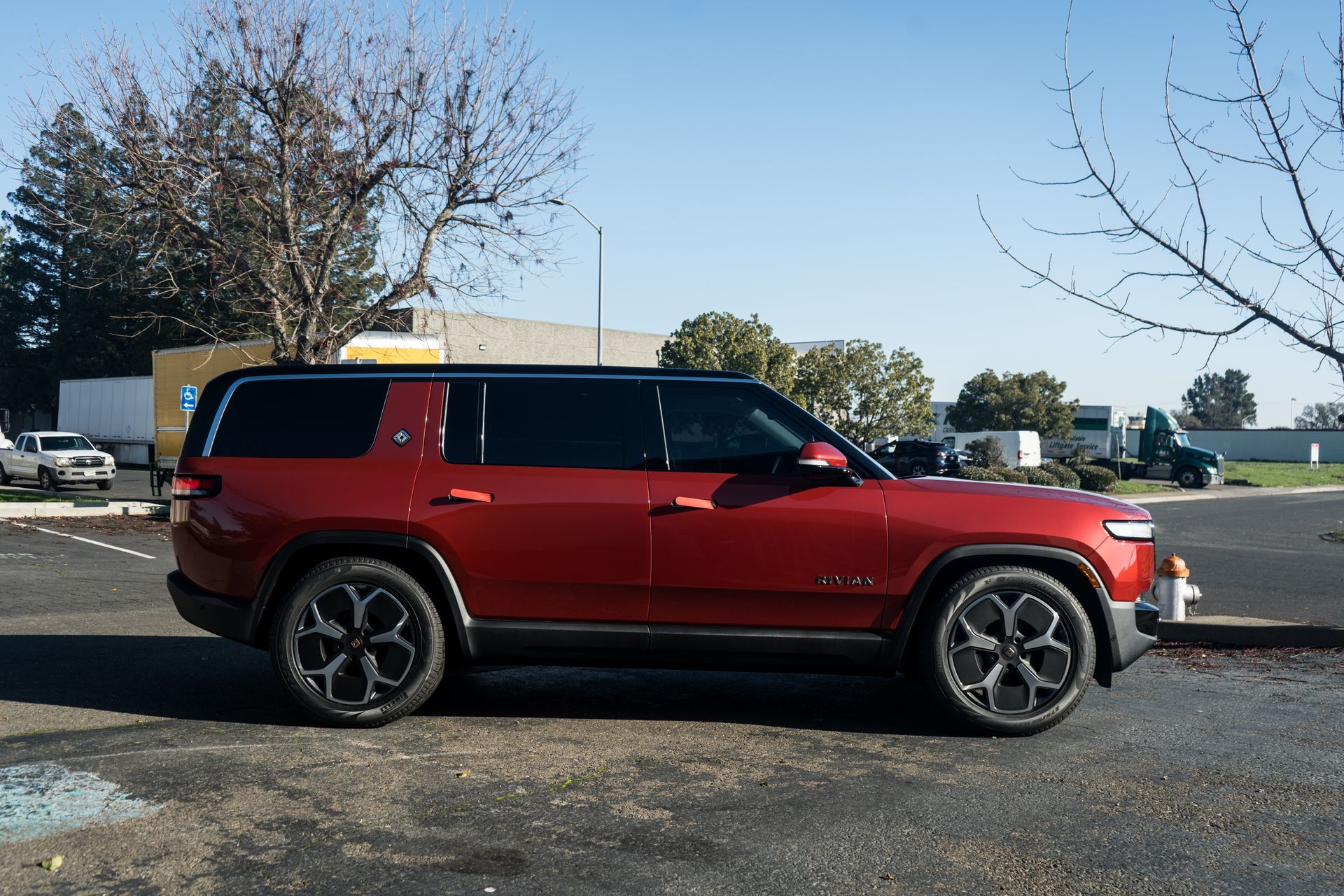 A red suv is parked in a parking lot.
