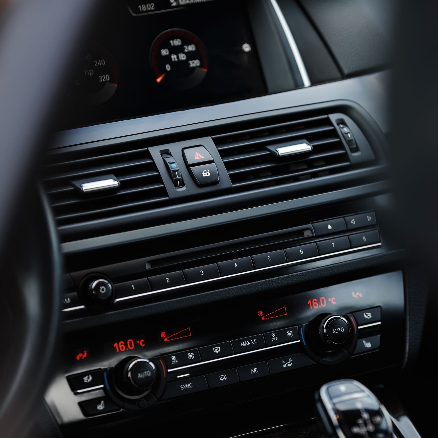 A close up of a car dashboard with a temperature of 16.0 degrees celsius