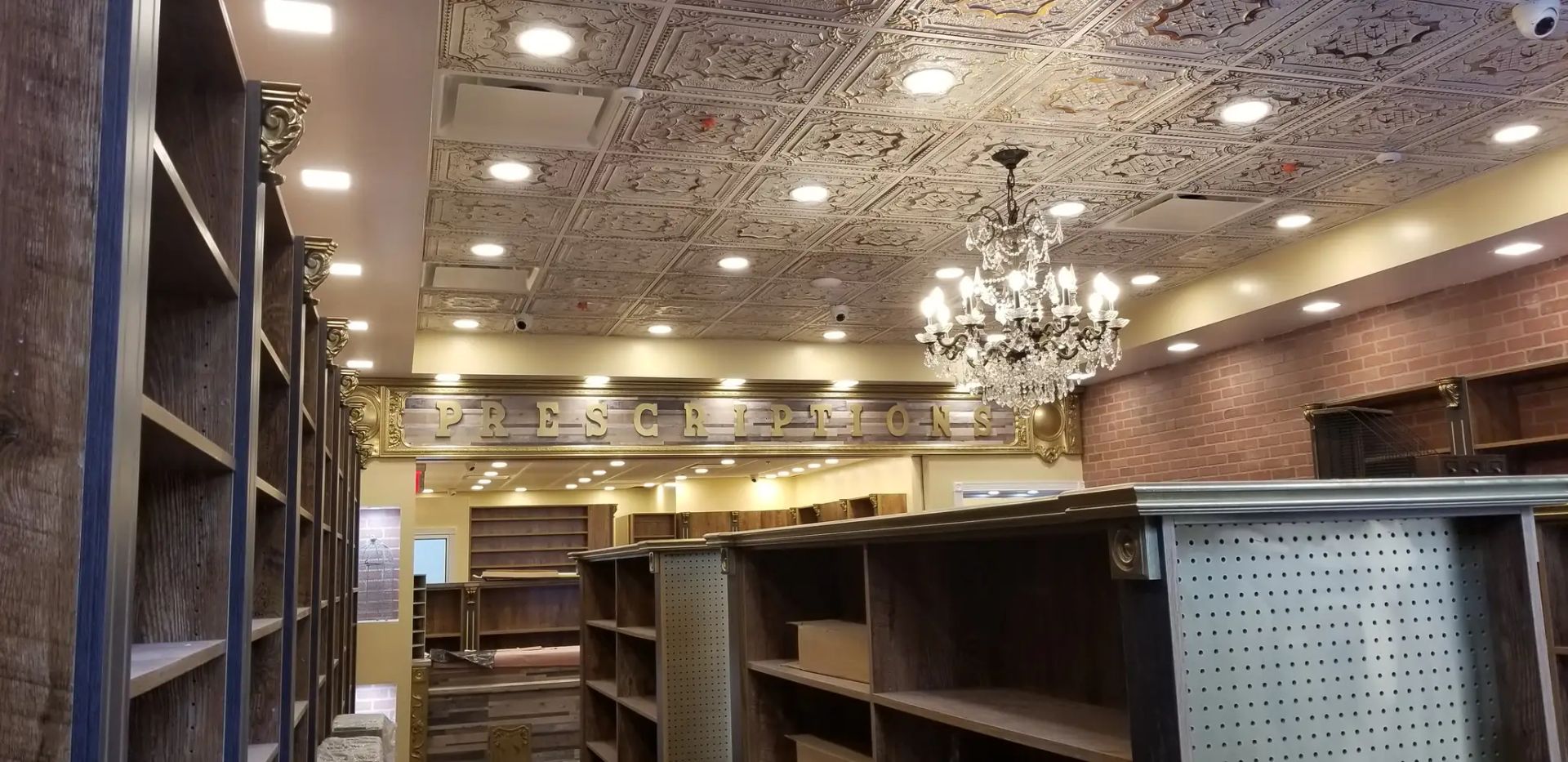 Empty ornate bookstore interior with bookshelves, chandeliers, and patterned ceiling lights