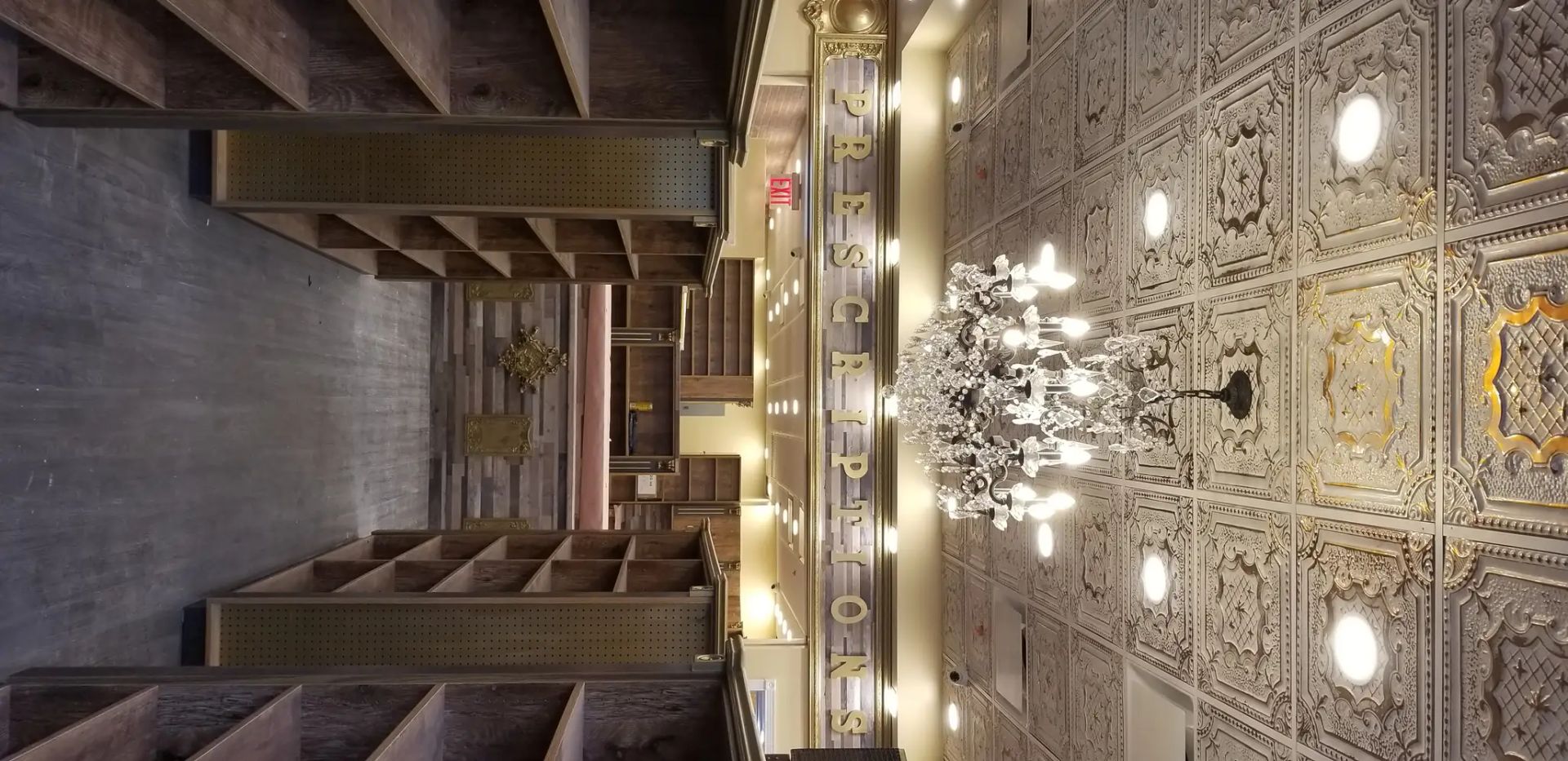 Grand hotel lobby with ornate chandelier ceiling, balcony railings, and a long carpeted hallway