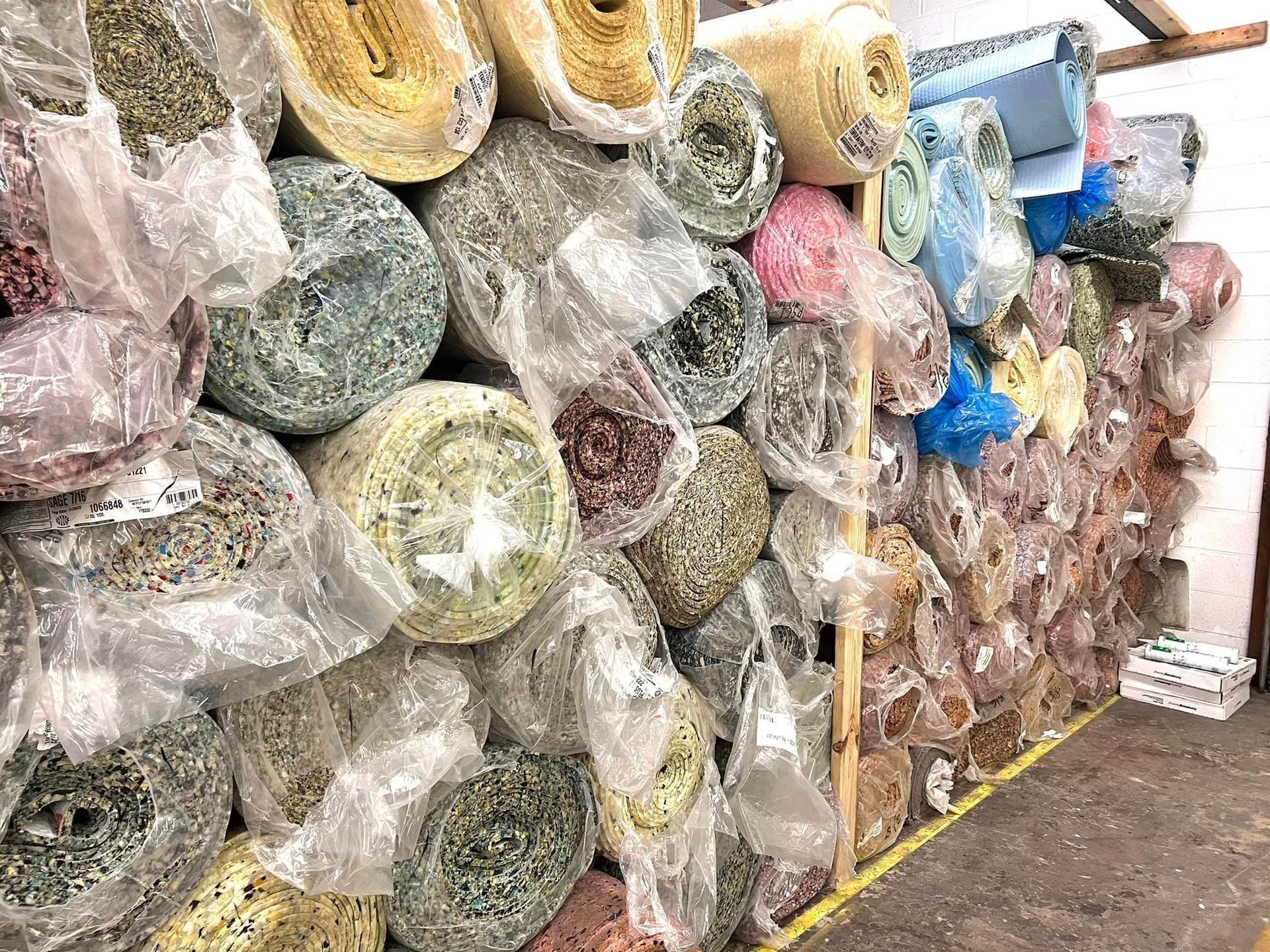 A bunch of rolls of fabric are stacked on top of each other.