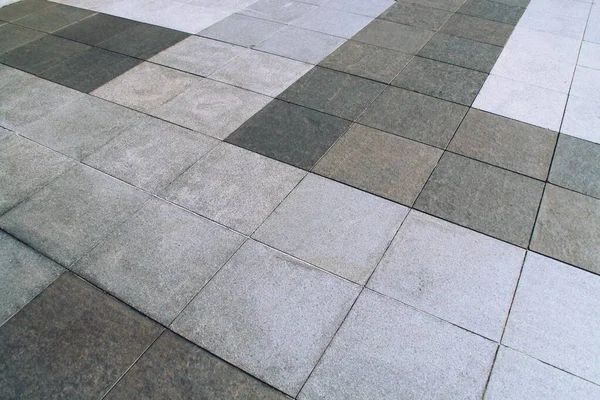 A close up of a tile floor that looks like wood.