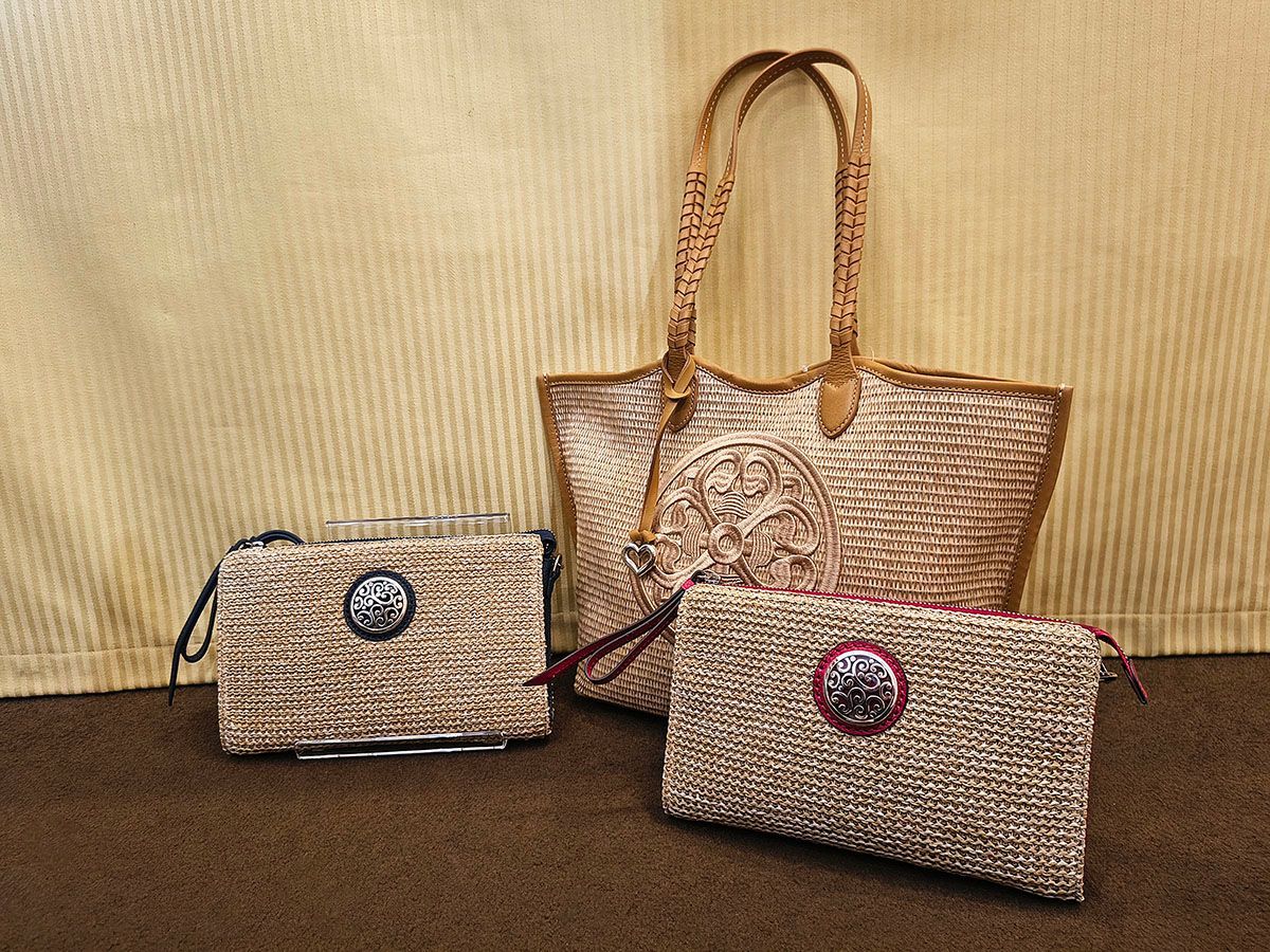Three woven straw handbags in tan and beige on a textured yellow background