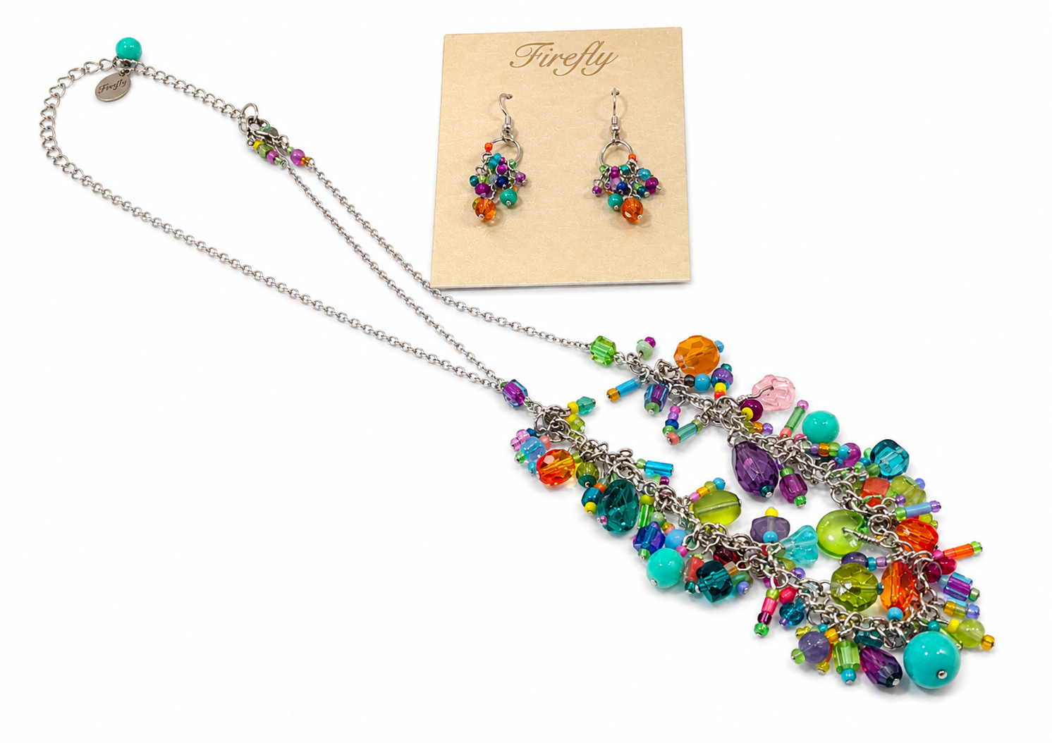 Colorful jeweled necklace and matching earrings displayed on a beige card with a rainbow cluster design