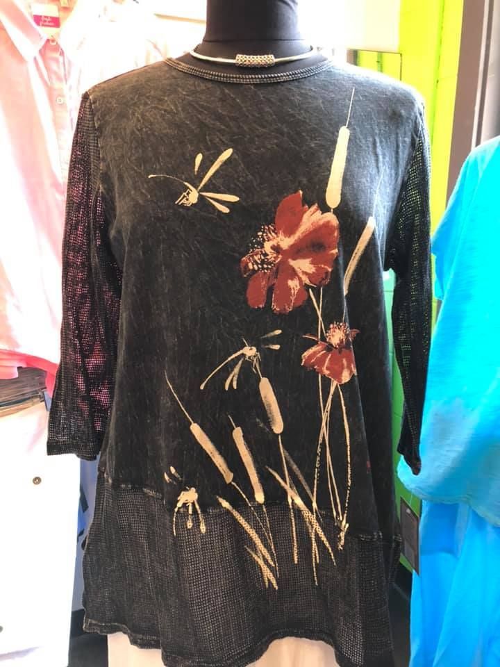 Black long-sleeve shirt with floral and grass print on a mannequin