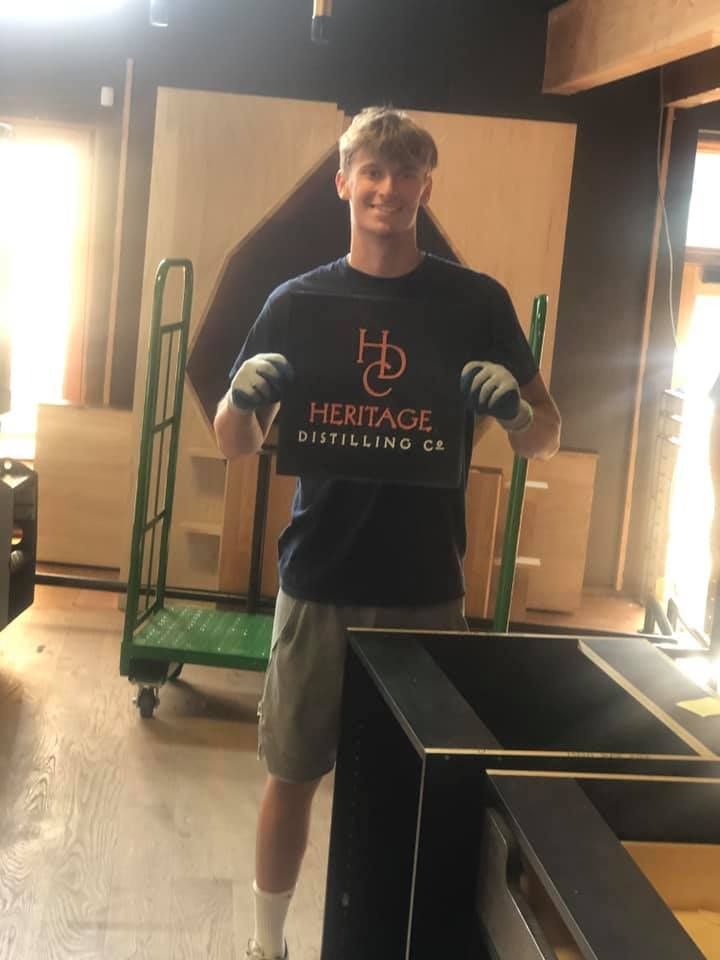 Man Holding A Sign — Puyallup, WA — Boush Moving & Storage Inc Man Holding A Sign — Puyallup, WA — Boush Moving & Storage Inc