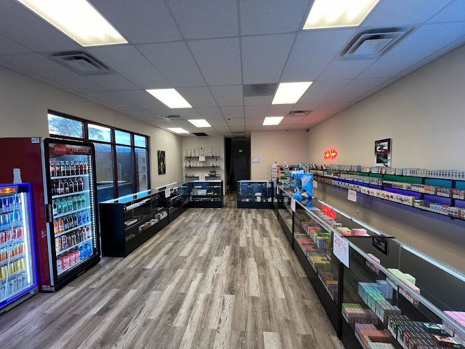 The inside of a store with a lot of shelves and a refrigerator.