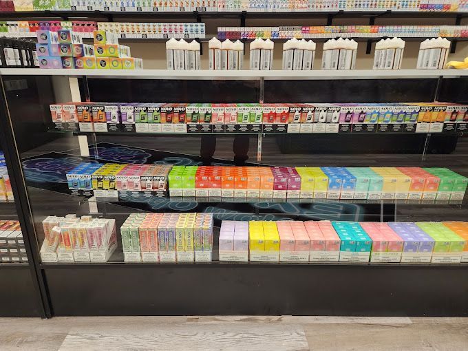 A display case filled with a variety of e-cigarettes in a store.