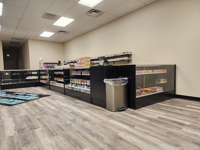 A store filled with lots of shelves and a trash can.