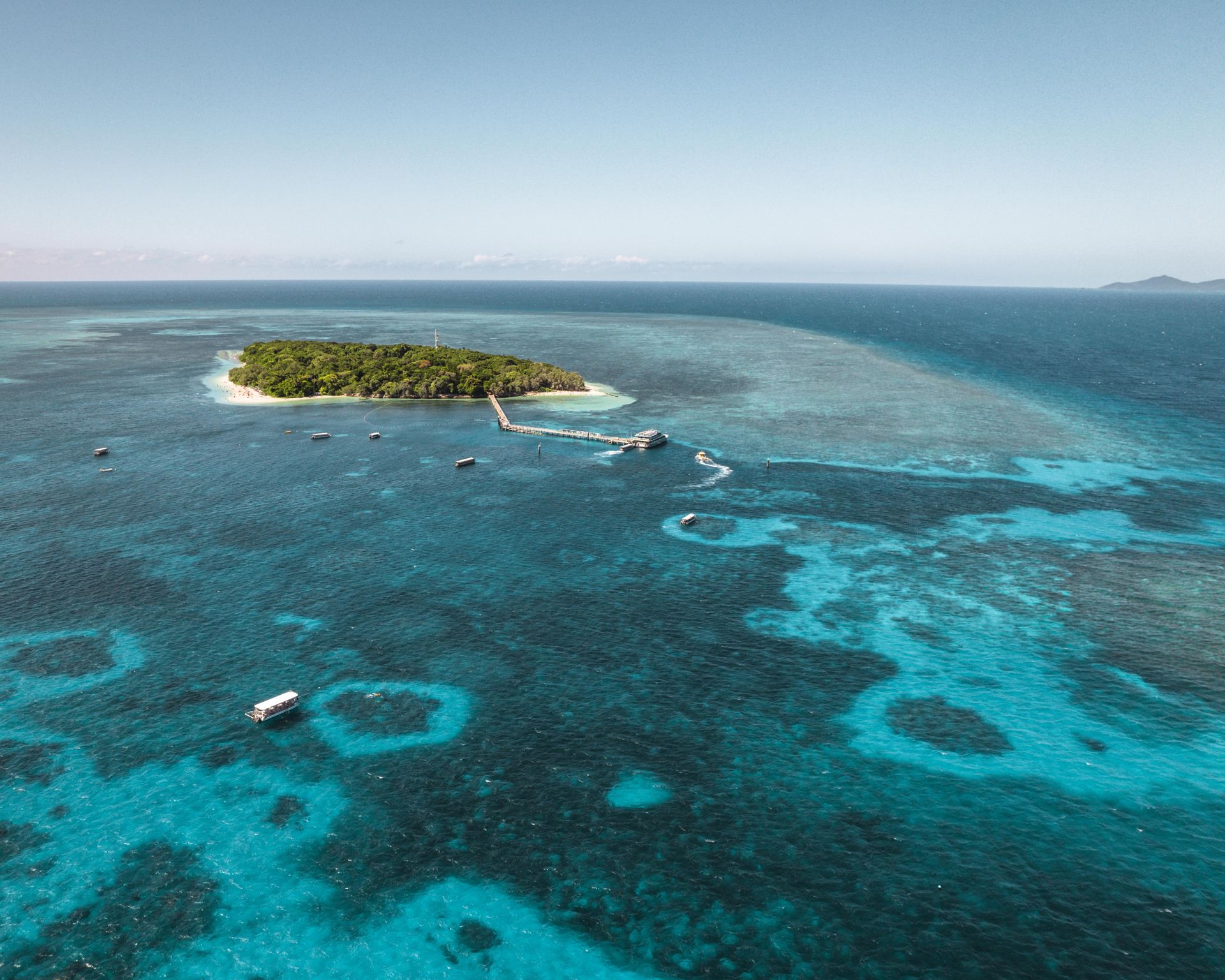Aerial view of Green Island surrounded by turquoise waters of the Great Barrier Reef Marine Park.