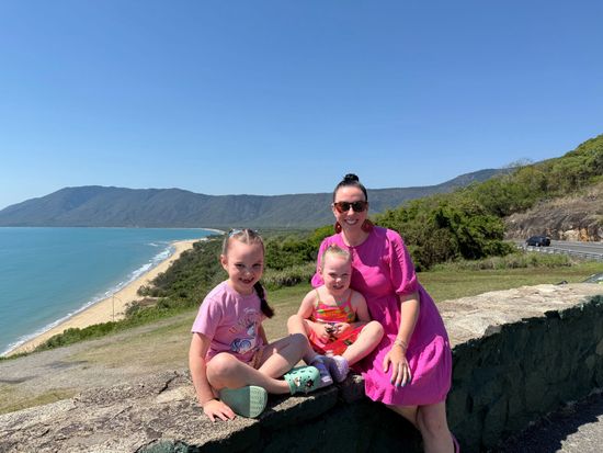 Megsi O'Toole with her daughters at a scenic lookout overlooking the coastline near Port Douglas