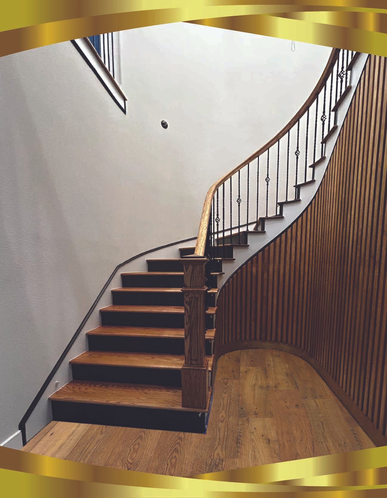 Indoor staircase with white risers, dark wood railings, and a beige carpeted landing.