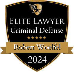 A shield with the words elite lawyer criminal defense robert woelfel 2024 on it.