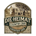 Logo for Die Heimat Country Inn, featuring a sketch of a historic building with the text "1856" in a decorative frame.