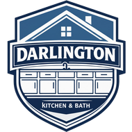 Logo for Darlington Kitchen & Bath featuring a blue and white shield with a house outline and kitchen cabinets.