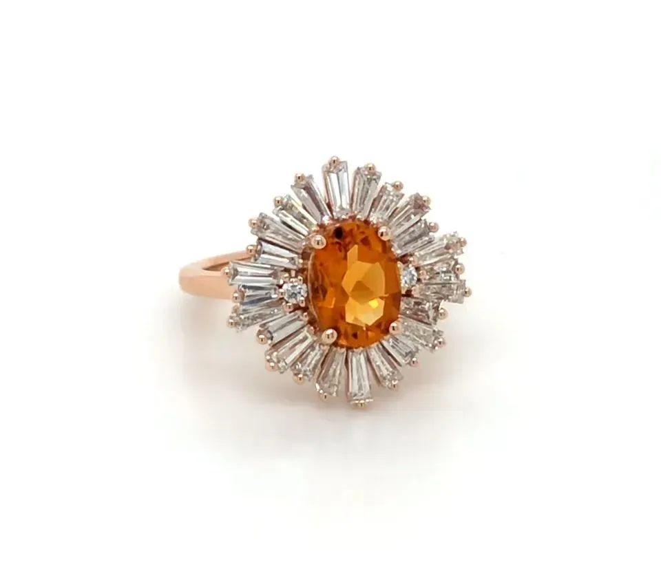 A ring with a sapphire and baguette diamonds on a white background.